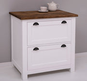 Fehér színű, tömör fenyőfából készült fiókos konyhaszekrény, sötétbarna fedlappal.