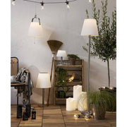 Cserepes növényekkel díszített szobabelső, polccal, LED gyertyákkal.