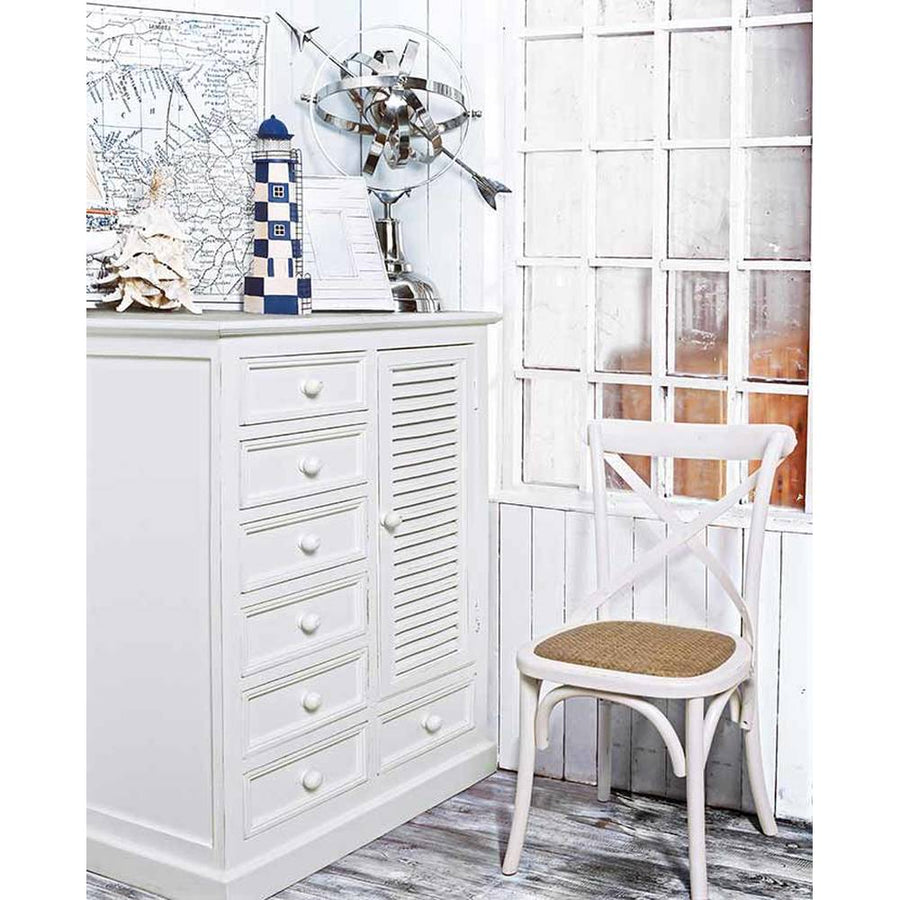 Tengerparti stílusú szobabelső fehér komóddal és fehér szilfa étkezőszékkel.