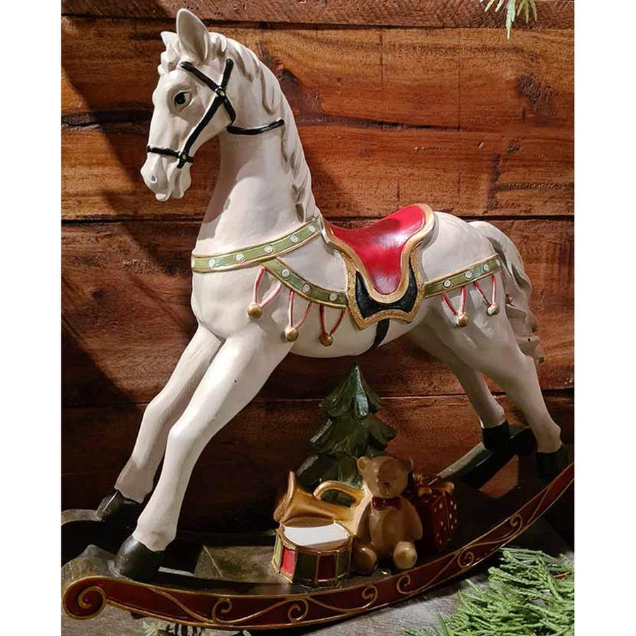 Vintage stílusú, 29,5 cm hosszú, fehér és piros színű karácsonyi hintaló ajándékokkal barna deszkafal előtt