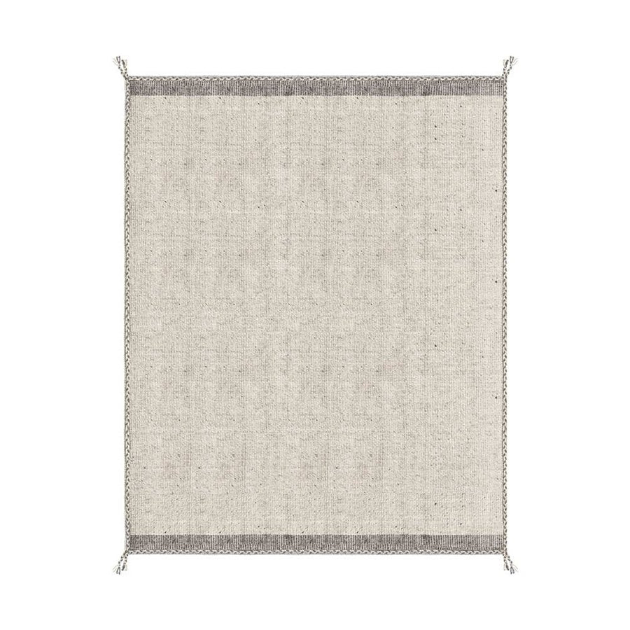 Bézs színű gyapjú szőnyeg.