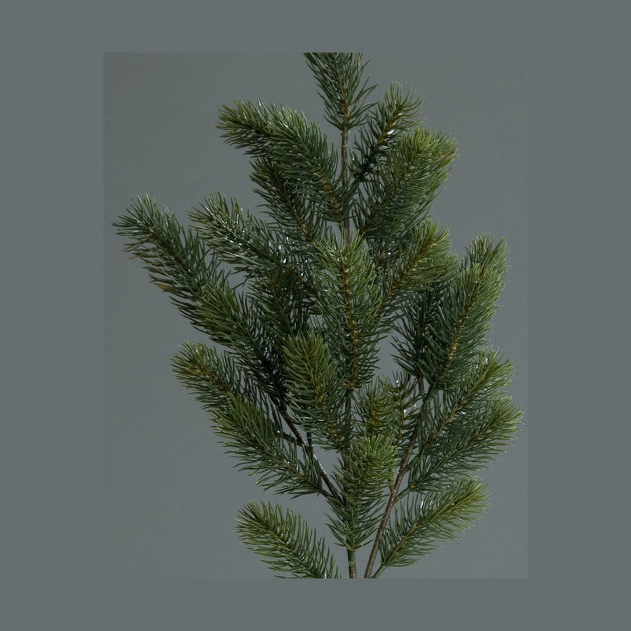 Zöld színű mesterséges jegenyefenyő ág.
