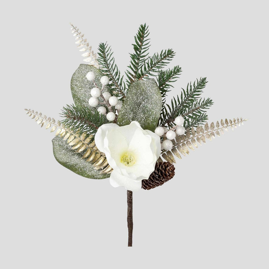 Fehér színű magnóliavirággal, pezsgőszínű páfrány levelekkel díszített, deres hatású fenyőág műnővény.