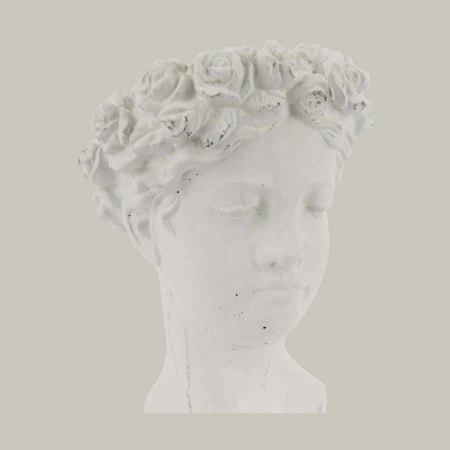 Antikolt felületű, krém színű kaspó büszt.