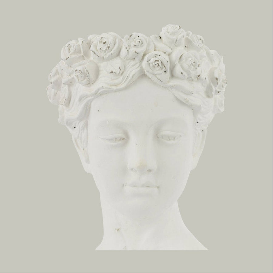 Antikolt felületű, krém színű kaspó büszt.