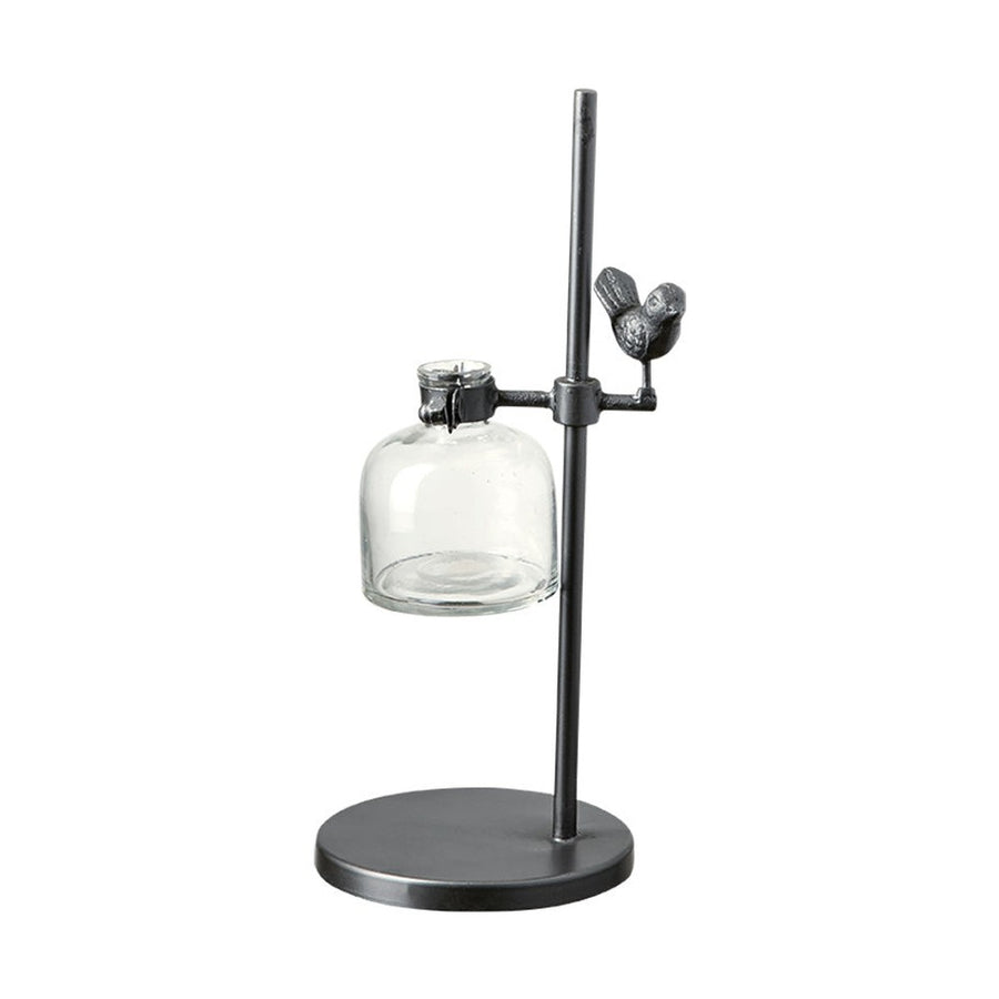 Loft stílusú,, madárral díszített, fém lombikállványba helyezett üveg váza.
