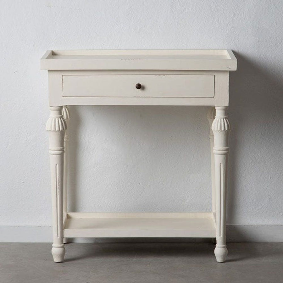 Provanszi stílusú, trópusi mindifából készült, faragott lábú, 72 cm hosszú, finoman antikolt, fehér színű fiókos konzolasztal szürke fal előtt