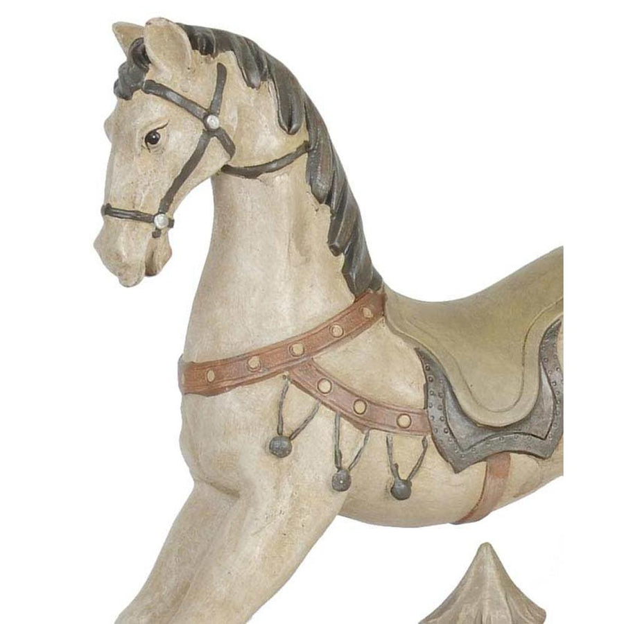 Antikolt felületű, krémszínű karácsonyi dekor hintaló.