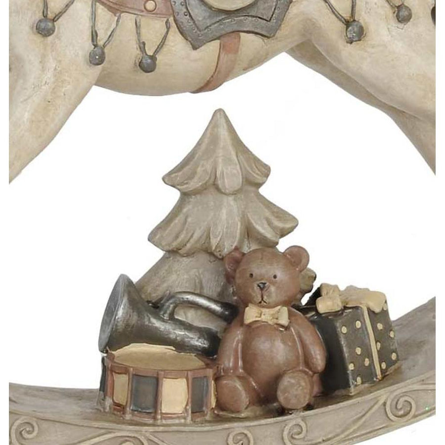 Antikolt felületű, krémszínű karácsonyi dekor hintaló.